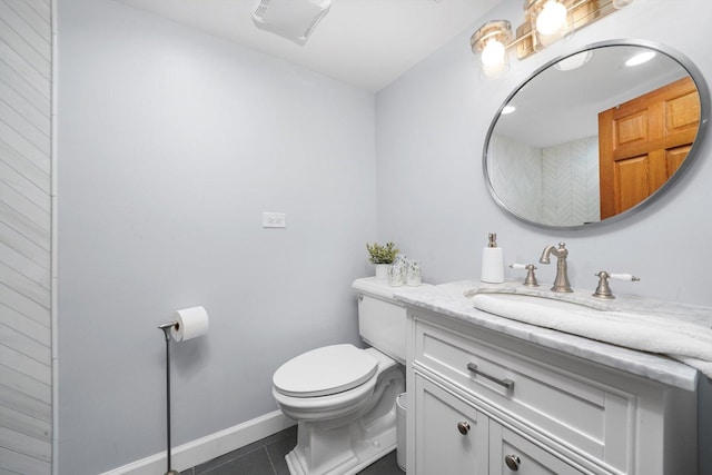 bathroom with vanity, tile patterned flooring, toilet, and baseboards