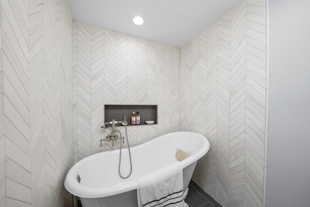 full bath featuring a freestanding bath, tile walls, and recessed lighting