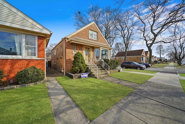 bungalow-style home featuring brick siding and a front yard