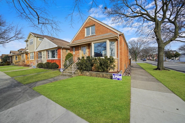 view of front facade featuring a front yard and brick siding