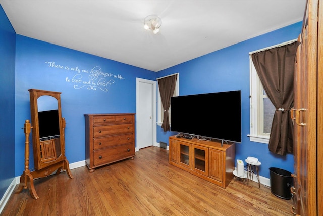 living room featuring wood finished floors and baseboards