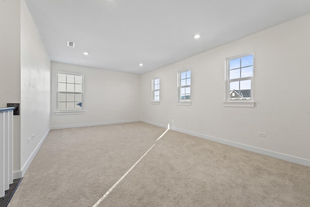 spare room with carpet floors, visible vents, baseboards, and recessed lighting