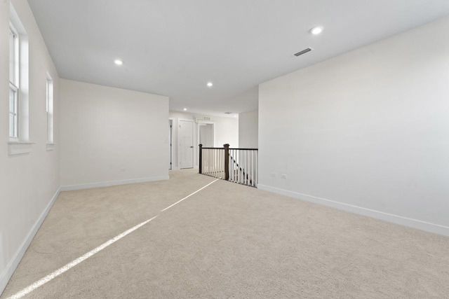 carpeted spare room with recessed lighting, visible vents, and baseboards