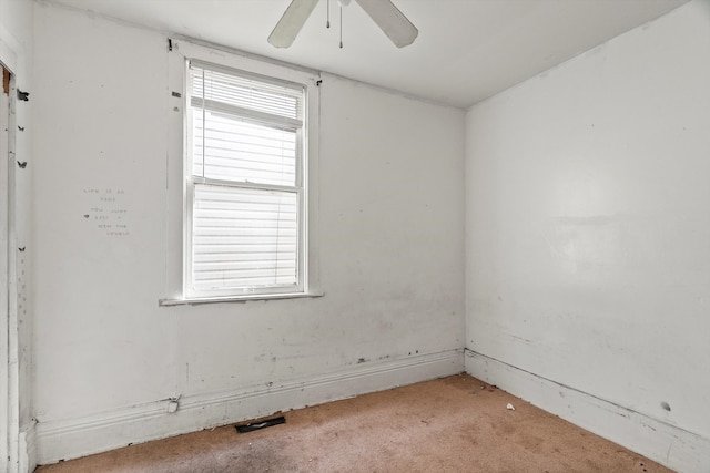 unfurnished room with a ceiling fan and light carpet