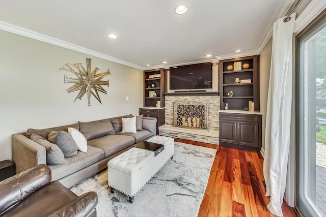 living room with a stone fireplace, crown molding, recessed lighting, and dark wood-style floors