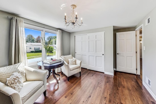 sitting room featuring visible vents, baseboards, a notable chandelier, and wood finished floors