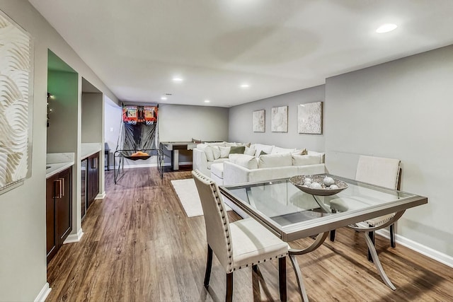 dining room with recessed lighting, dark wood-style floors, and baseboards