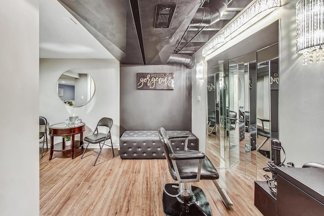 exercise room featuring visible vents and wood finished floors