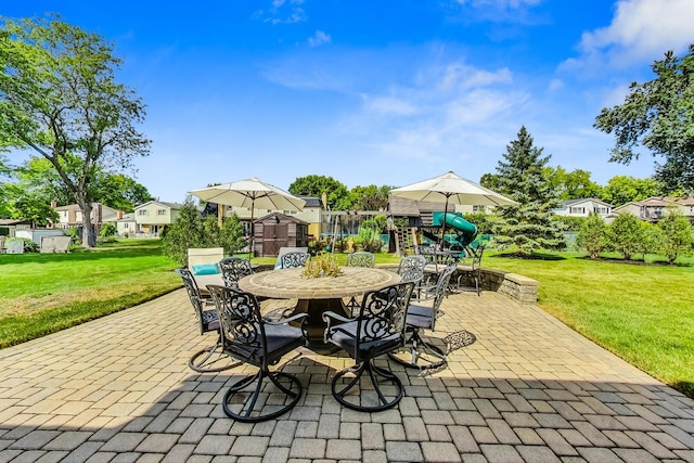 view of patio featuring outdoor dining space and a playground