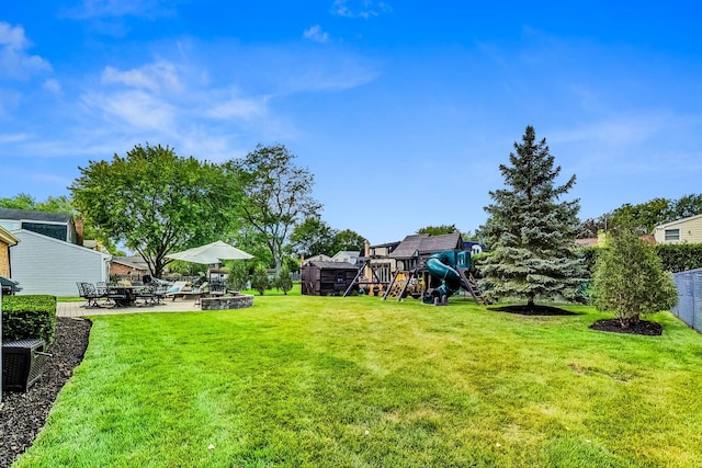 view of yard with a patio and a playground