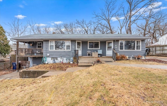 single story home with a porch, a front yard, and fence