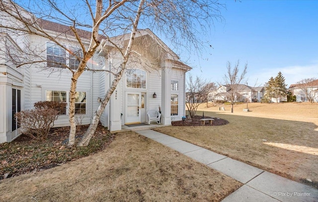 rear view of property featuring a yard