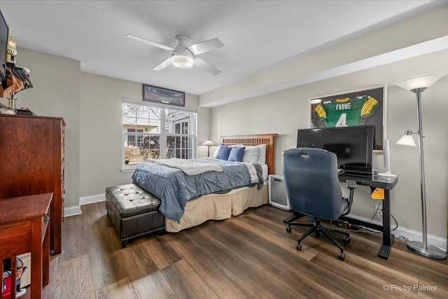 bedroom featuring ceiling fan, baseboards, and dark wood finished floors