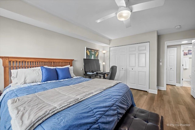 bedroom with a ceiling fan, a closet, baseboards, and wood finished floors