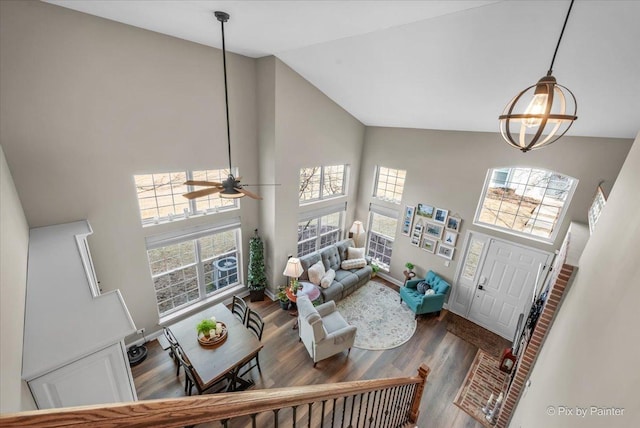 living area featuring high vaulted ceiling, wood finished floors, a wealth of natural light, and a ceiling fan