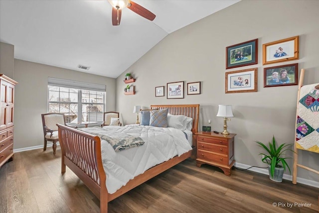 bedroom featuring visible vents, baseboards, vaulted ceiling, and wood finished floors