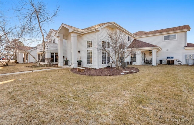 neoclassical home featuring a front yard