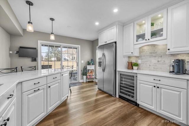 kitchen featuring beverage cooler, white cabinetry, dark wood-style floors, tasteful backsplash, and stainless steel fridge