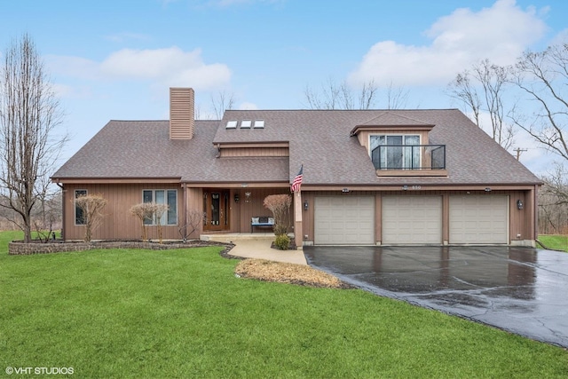 view of front facade featuring a balcony, a garage, a front yard, and roof with shingles