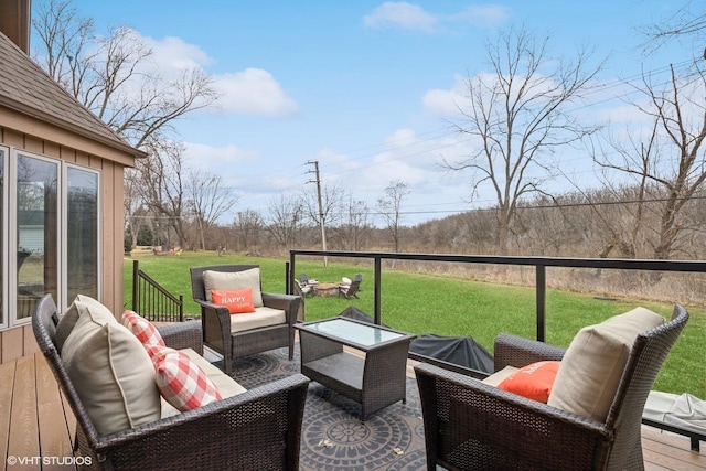 wooden deck with outdoor lounge area and a lawn