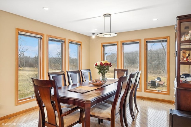 dining space with light wood finished floors, recessed lighting, and baseboards