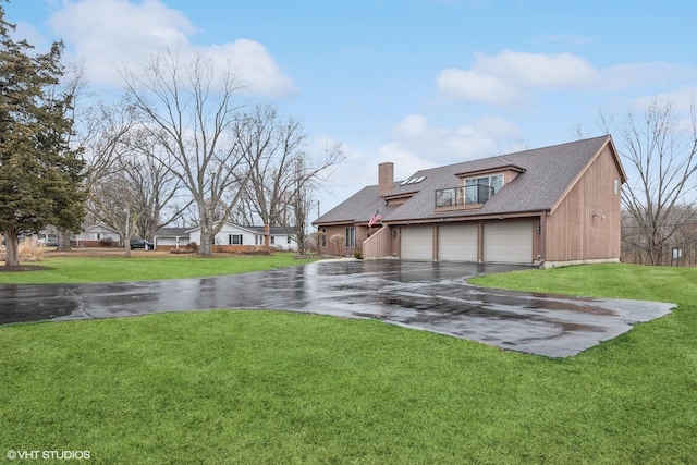 exterior space featuring a garage, driveway, a chimney, roof with shingles, and a yard