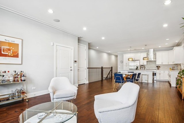 living room featuring recessed lighting, dark wood-style flooring, and ornamental molding