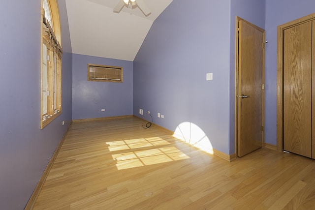 bonus room featuring lofted ceiling, ceiling fan, light wood-style flooring, and baseboards