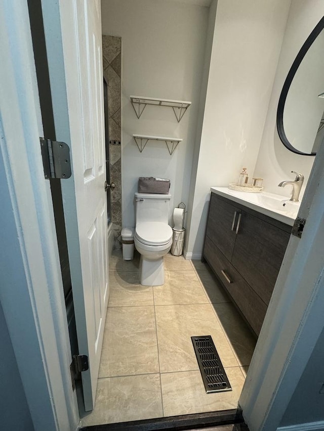 bathroom featuring visible vents, toilet, tile patterned flooring, baseboards, and vanity