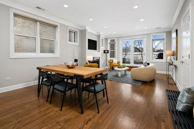 dining area with dark wood finished floors, crown molding, baseboards, and recessed lighting