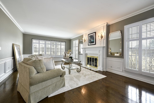 living room featuring ornamental molding, dark wood-style flooring, and a glass covered fireplace