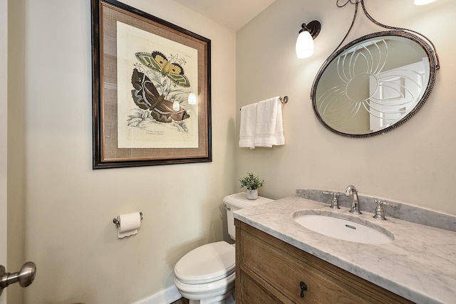 bathroom with toilet and vanity