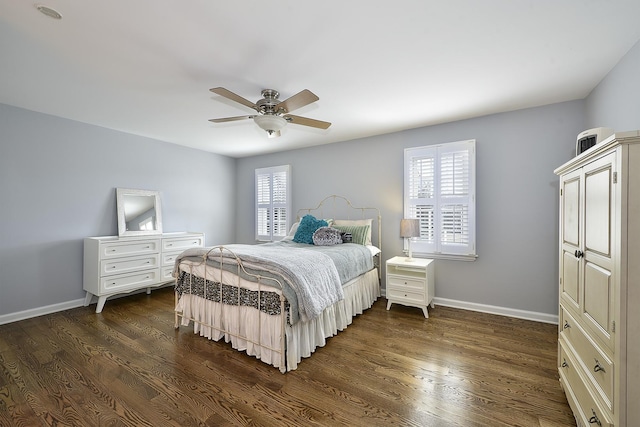 bedroom with dark wood-style floors, ceiling fan, multiple windows, and baseboards