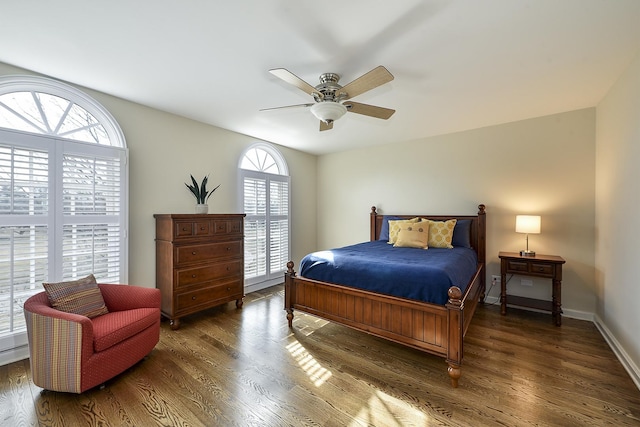 bedroom featuring a ceiling fan, baseboards, and wood finished floors