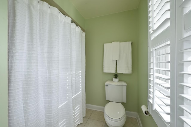 full bath featuring tile patterned flooring, toilet, and baseboards