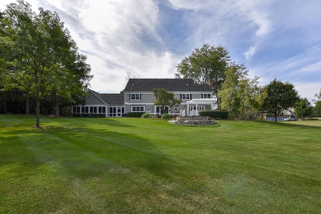 rear view of property with a lawn