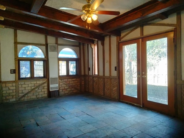 interior space featuring beamed ceiling, french doors, and ceiling fan