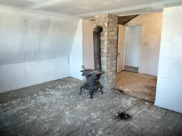 unfurnished living room featuring a wood stove