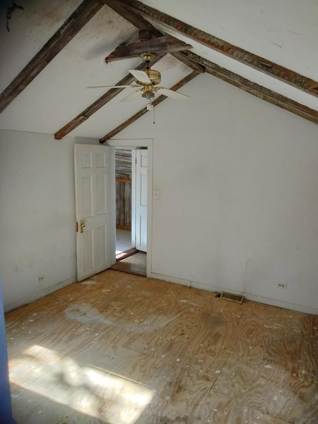 unfurnished room featuring visible vents, lofted ceiling with beams, and a ceiling fan