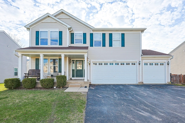 704 Doral Dr, Marengo, IL 60152 - view of front facade featuring covered porch, a garage, aphalt driveway, fence, and a front lawn