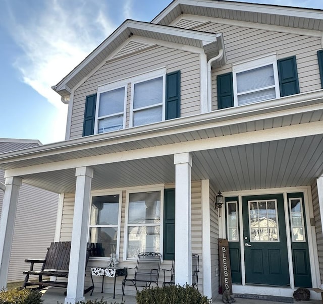 view of exterior entry with covered porch