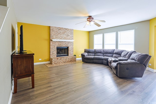 704 Doral Dr, Marengo, IL 60152 - living room featuring wood finished floors, ceiling fan, baseboards, and a fireplace