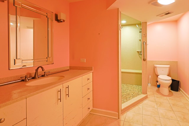 704 Doral Dr, Marengo, IL 60152 - full bathroom featuring visible vents, toilet, vanity, tile patterned flooring, and a stall shower