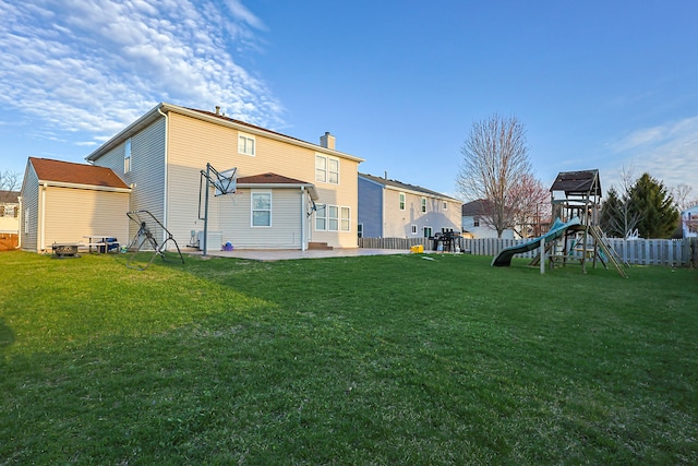 704 Doral Dr, Marengo, IL 60152 - back of property featuring fence, a playground, a patio, and a lawn