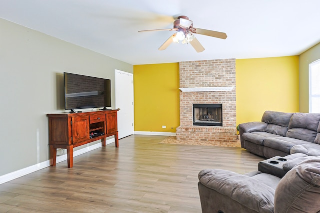 704 Doral Dr, Marengo, IL 60152 - living area with baseboards, a ceiling fan, wood finished floors, and a fireplace