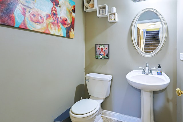 704 Doral Dr, Marengo, IL 60152 - bathroom featuring a sink, toilet, and baseboards