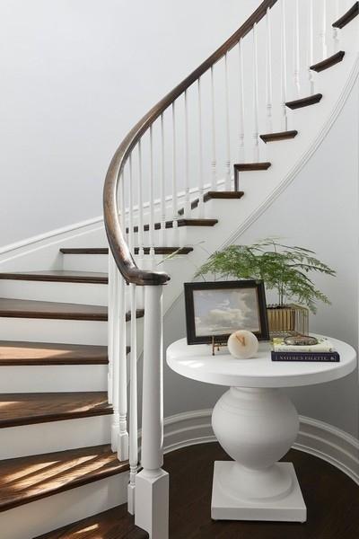 staircase with baseboards and wood finished floors