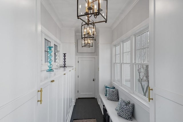 mudroom with a chandelier and crown molding