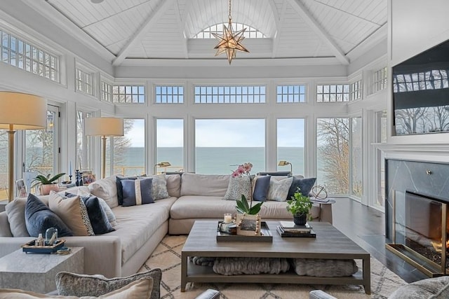 sunroom featuring lofted ceiling and a premium fireplace