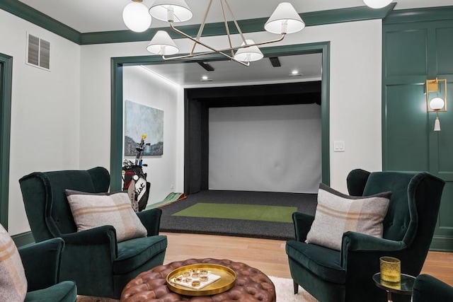 recreation room with visible vents, golf simulator, wood finished floors, and crown molding